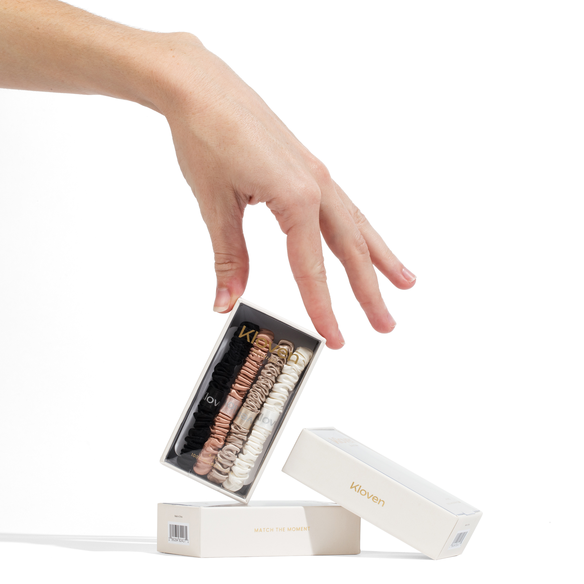 Hand reaching for Kloven gift box packaging