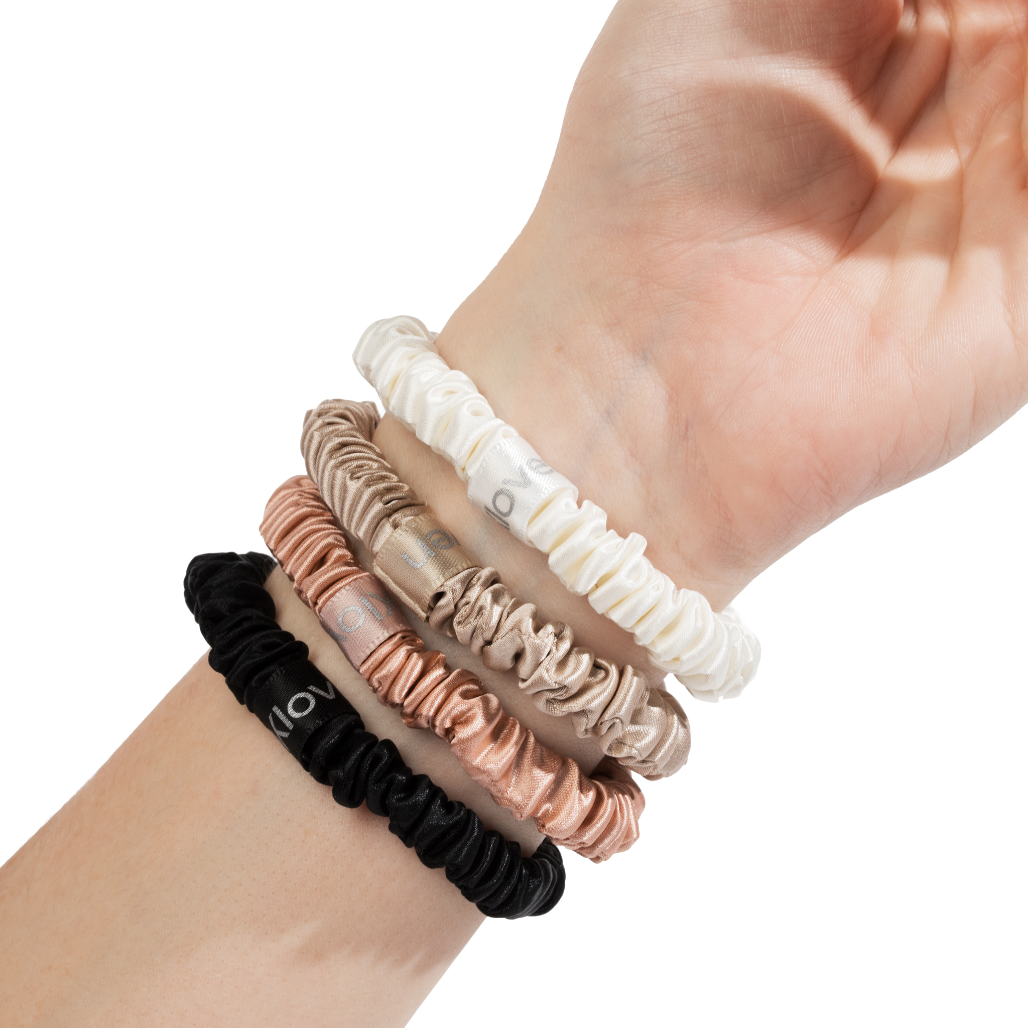 All four Kloven silk scrunchies worn on wrist